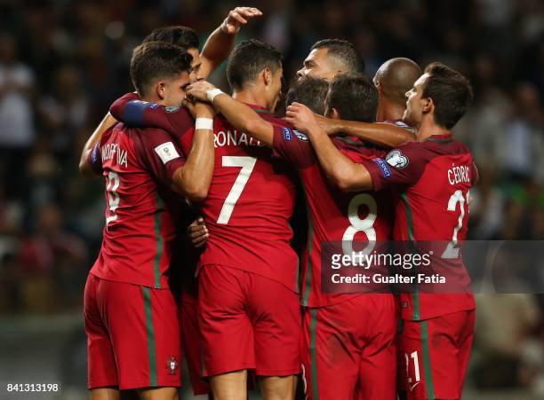 Portugal midfielder William Carvalho celebrates with teammates after scoring a goal during the FIFA 2018 World Cup Qualifier match between Portugal...
