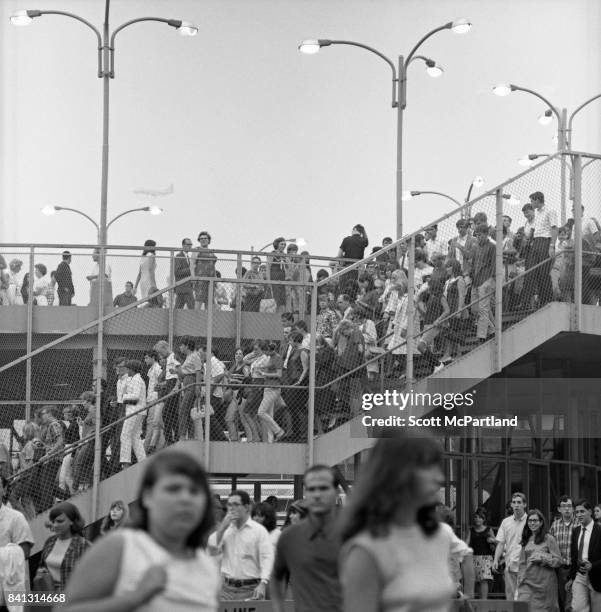 Shea Stadium 8.23.1966: Hundreds of Beatles fans exit the 7 Train Subway stop in Corona Queens, on their way to see The Beatles at Shea on their last...