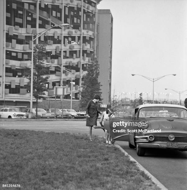 Shea Stadium 8.23.1966: A mother exits a classic Buick with her young daughter in the parking lot of Shea, prior to The Beatles taking the stage on...