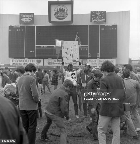 Shea Stadium : Fan appreciation spirals out of control, as some begin to cut large chunks of grass out of the field, while another holds a sign over...