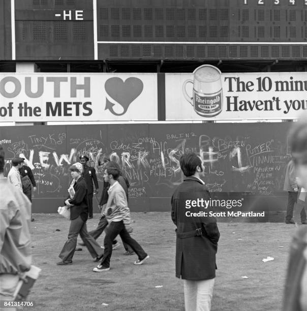Shea Stadium : Fan celebration spirals out of control, as some vandalize the back wall of the stadium with graffitti, after the Mets win it all in...