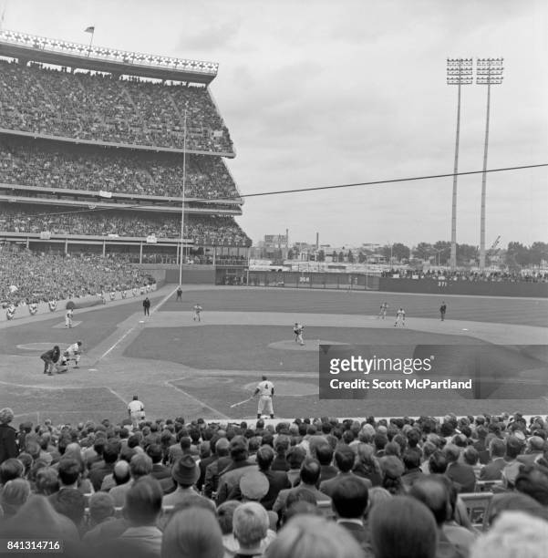Shea Stadium : Taken from the right field side behind 1st base of fans watching intently, as game 5 of the 1969 World Series gets underway, as the...