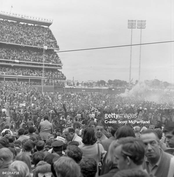 Shea Stadium : Smoke canisters are set off, as fan appreciation spirals out of control, and thousands of fans storm the field after the NY Mets win...