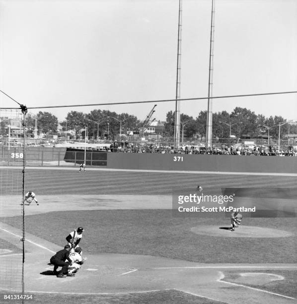 Shea Stadium : A pitcher for the Orioles fires a fast ball from the mound, as a Mets batter prepares to swing during Game 5 of the World Series