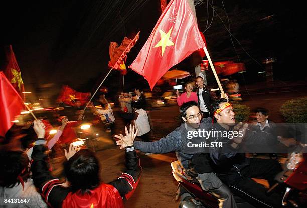 Vietnamese fans celebrate after their national football team won the AFF Suzuki Cup final match on December 28, 2008 in downtown Hanoi. Vietnam...