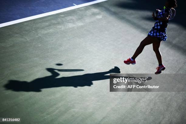 Japan's Risa Ozaki returns the ball to China's Shuai Zhang during their 2017 US Open Women's Singles match at the USTA Billie Jean King National...