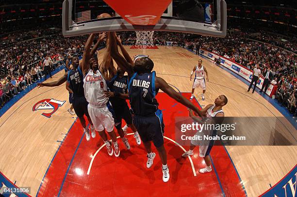 DeAndre Jordan of the Los Angeles Clippers has his shot contested by Brandon Bass, Josh Howard, and DeSagana Diop of the Dallas Mavericks at Staples...