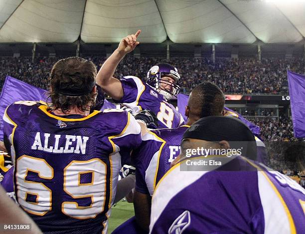 Ryan Longwell of the Minnesota Vikings is hoisted up by teammates after he kicked the game winning field goal against the New York Giants on December...