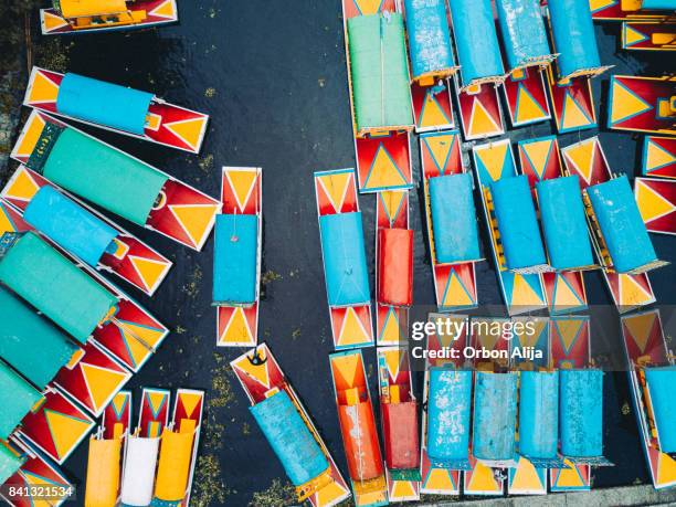 'trajinera' boats in the xochimilco's canals, mexico city. - xochimilco stock pictures, royalty-free photos & images