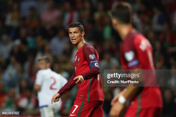 Portugal's forward Cristiano Ronaldo reacts with Portugal's forward Andre Silva during the FIFA World Cup Russia 2018 qualifier match between...