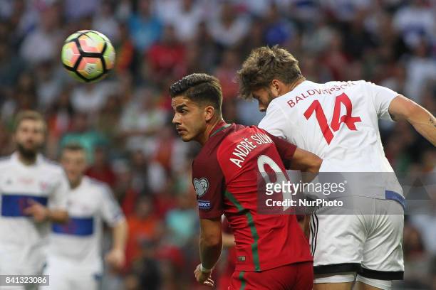Portugal's forward Andre Silva with Rogvi Baldvinsson midfielder of Ilhas Faroe during the FIFA World Cup Russia 2018 qualifier match between...