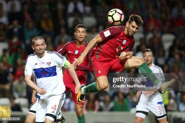 Portugal's forward Nelson Oliveira heads the ball during the 2018 FIFA World Cup qualifying football match between Portugal and Faroe Islands at the...