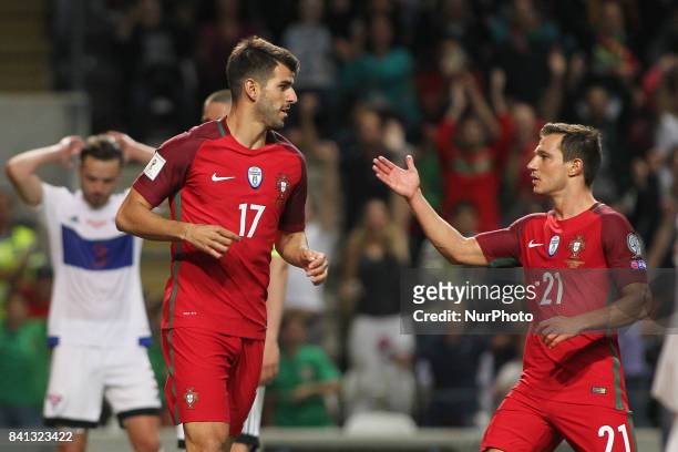 Portugal's forward Nelson Oliveira celebrates after scoring goal with Portugal's defender Cedric during the FIFA World Cup Russia 2018 qualifier...