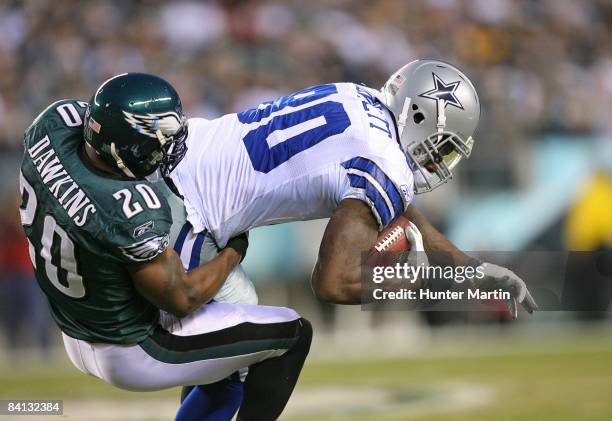 Safety Brian Dawkins of the Philadelphia Eagles tackles tight end Martellus Bennett of the Dallas Cowboys during a game on December 28, 2008 at...