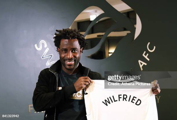 Wilfried Bony holds a home shirt at the Swansea City FC Fairwood Training Ground on August 31, 2017 in Swansea, Wales.