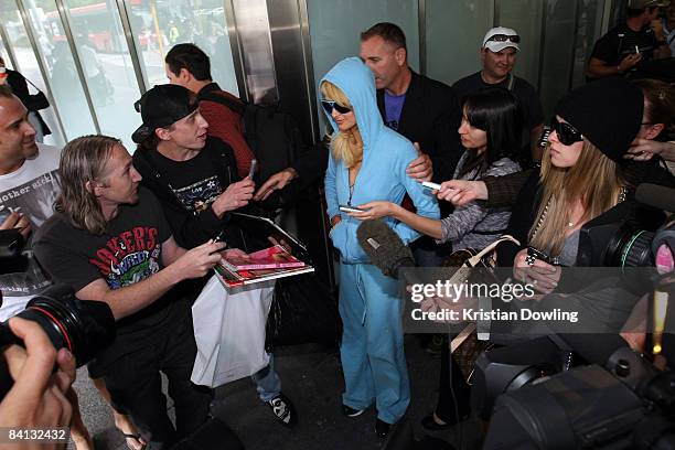 Socialites Paris Hilton and Nicky Hilton are surrounded by media and autograph hunters as they arrive at Melbourne Airport on December 29, 2008 in...