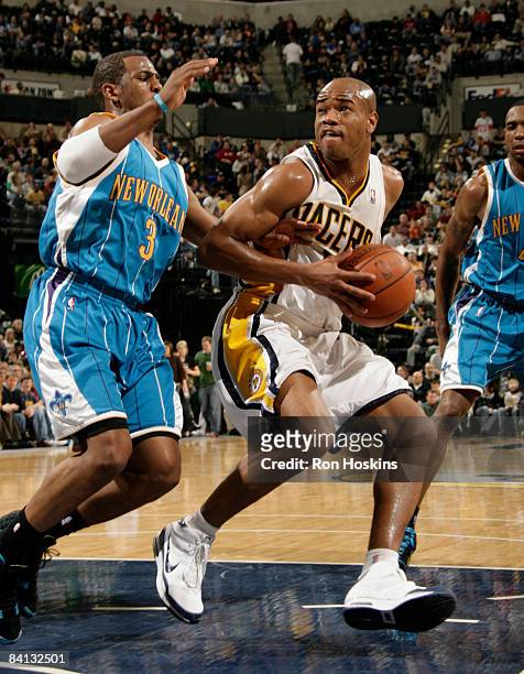 Jarrett Jack of the Indiana Pacers looks to score on Chris Paul of the New Orleans Hornets at Conseco Fieldhouse on December 28, 2008 in...