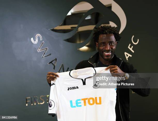 Wilfried Bony holds a home shirt at the Swansea City FC Fairwood Training Ground on August 31, 2017 in Swansea, Wales.