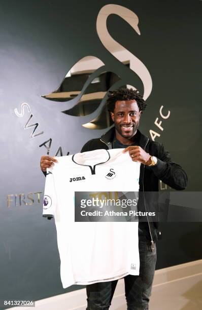 Wilfried Bony holds a home shirt at the Swansea City FC Fairwood Training Ground on August 31, 2017 in Swansea, Wales.
