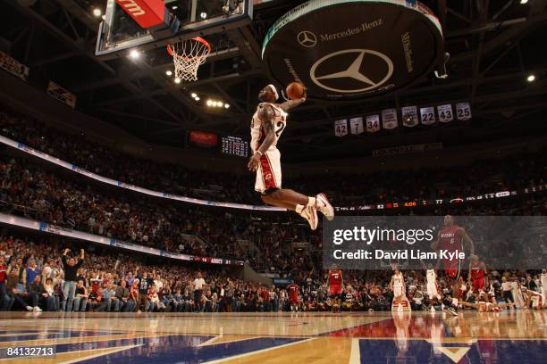 LeBron James of the Cleveland Cavaliers flies in for the dunk trailed by Mario Chalmers of the Miami Heat at The Quicken Loans Arena on December 28,...