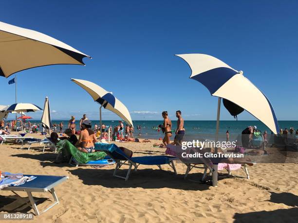bibione - beach and umbrellas - bibione stock pictures, royalty-free photos & images