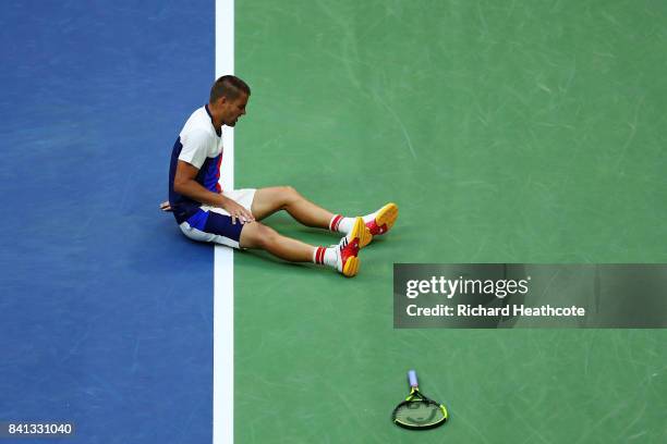 Mikhail Youzhny of Russia reacts on the ground against Roger Federer of Switzerland during their second round Men's Singles match on Day Four of the...