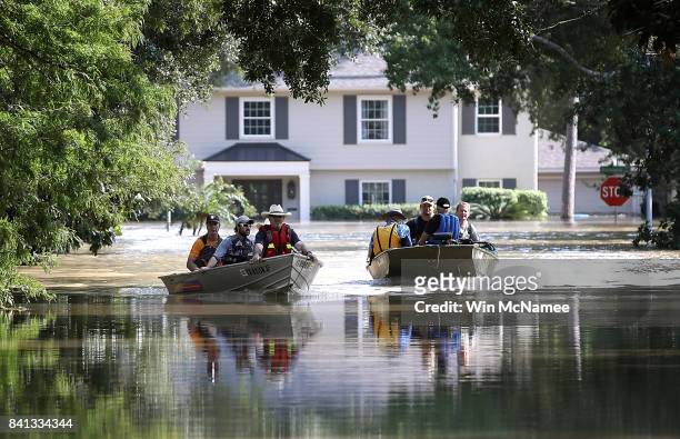Residents in a neighborhood near the Barker Reservoir return to their homes to collect belongings August 31, 2017 in Houston, Texas. The...