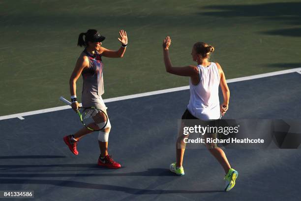 Saisai Zheng of China and Alla Kudryavtseva of Russia react against Taylor Johnson and Claire Liu of the United States during their first round Wom...