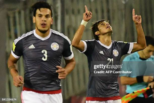 Paraguay's Gustavo Gomez and Oscar Romero celebrate after Chile's Arturo Vidal scored an own goal during their 2018 World Cup qualifier football...