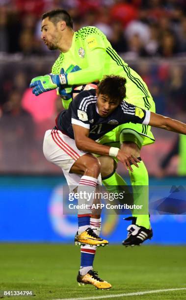 Paraguay's goalkeeper Antony Silva collides with teammate Oscar Romero during the 2018 World Cup qualifier football match against Chile, in Santiago,...