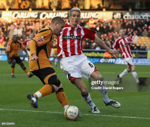 Michael Knightly of Wolves takes on Matthew Kilgallon during the Coca-Cola Championship match between Wolverhampton Wanderers and Sheffield United at...