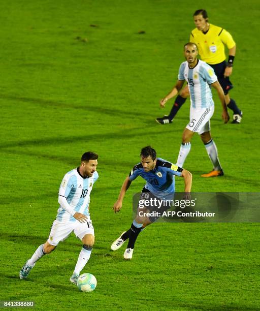 Argentina's Lionel Messi is marked by Uruguay's Alvaro Gonzalez during their 2018 World Cup qualifier football match in Montevideo, on August 31,...