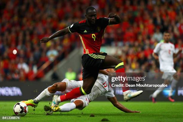 Romelu Lukaku of Belgium is tackled by Jason Pusey of Gibraltar during the FIFA 2018 World Cup Qualifier between Belgium and Gibraltar at Stade...