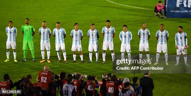 Players of Argentina listen to their national anthem before the start of the 2018 World Cup football qualifier match against Uruguay in Montevideo,...