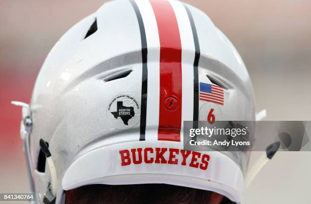 The Ohio State Buckeyes are wearing stickers on their helmets showing their support for the those affected by Hurricane Harvey in their game against...