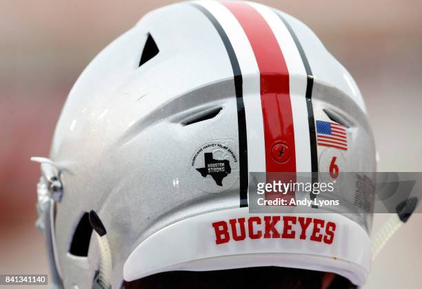The Ohio State Buckeyes are wearing stickers on their helmets showing their support for the those affected by Hurricane Harvey in their game against...