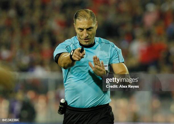 Referee Nestor Pitana gestures during a match between Chile and Paraguay as part of FIFA 2018 World Cup Qualifiers at Monumental Stadium on August...