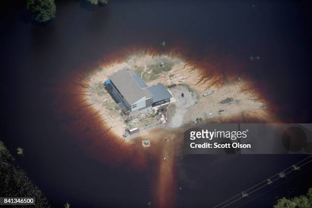Home is surrounded by floodwater after torrential rains pounded Southeast Texas following Hurricane and Tropical Storm Harvey on August 31, 2017 near...