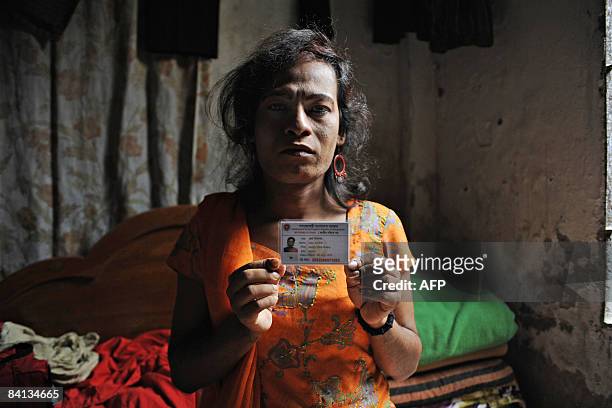 Bangladeshi 'hijra' social worker Joya Shikder holds her national identity card at her house in Dhaka on December 26, 2008. Among the millions of new...