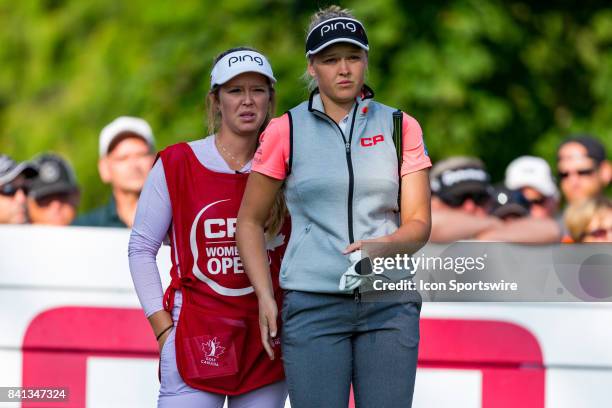 Brooke Henderson and her sister/caddie Brittany Henderson discuss strategy before teeing off on the 1st hole during the third round of the Canadian...