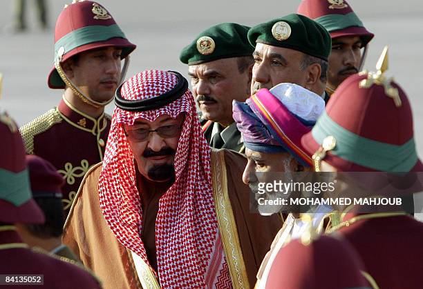 Sultan Qaboos of Oman escorts Saudi King Abdullah bin Abdul Aziz al-Saud upon his arrival at Muscat airport on December 29 to attend a Gulf...
