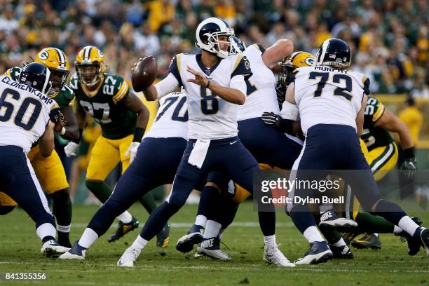 Dan Orlovsky of the Los Angeles Rams drops back to pass in the second quarter against the Green Bay Packers during a preseason game at Lambeau Field...