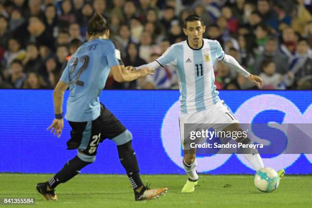 Martin Caceres of Uruguay and Angel Di Maria of Argentina fight for the ball during a match between Uruguay and Argentina as part of FIFA 2018 World...