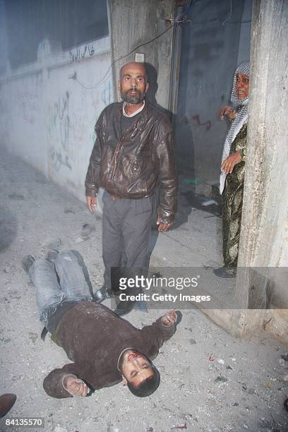 Wounded Palestinian man lies on the floor after an Israeli missile struck the neighbouring home of a Hamas military leader on December 29, 2008 in...