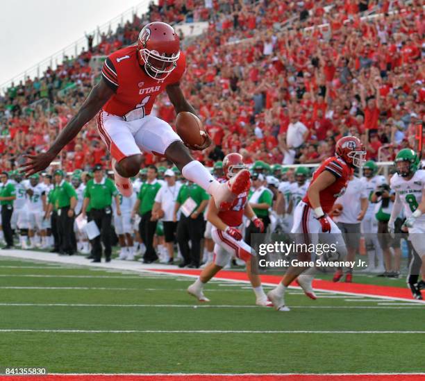 Quarterback Tyler Huntley of the Utah Utes scores a first half touchdown against the North Dakota Fighting Hawks at Rice-Eccles Stadium on August 31,...