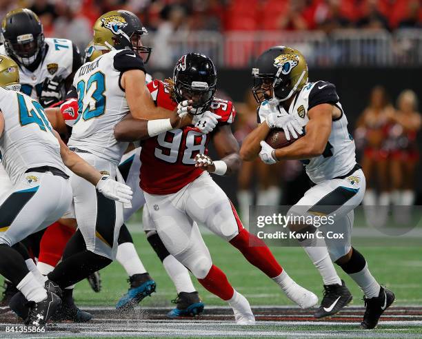 Takkarist McKinley of the Atlanta Falcons gives chases to Jonathan Grimes of the Jacksonville Jaguars at Mercedes-Benz Stadium on August 31, 2017 in...