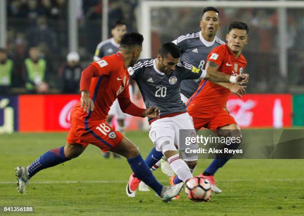 Antonio Bareiro of Paraguay fights for the ball with Charles Aranguiz of Chile, during a match between Chile and Paraguay as part of FIFA 2018 World...