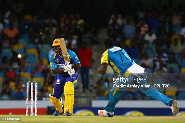 In this handout image provided by CPL T20, Dwayne Smith of Barbados Tridents plays the ball down the ground as Jerome Taylor of the St Lucia Stars...