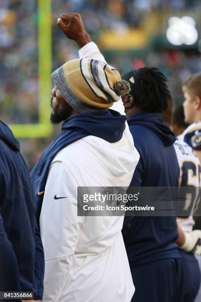 Los Angeles Rams linebacker Robert Quinn stands in silent protest during a game between the Green Bay Packers and the Los Angeles Rams on August 31,...