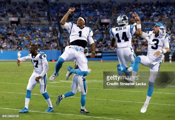 Teammates Cam Newton, Joe Webb and Derek Anderson of the Carolina Panthers react after a play during their game against the Pittsburgh Steelers at...